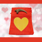 Deinonychus claw cast with Red Bag/Gold Heart gift bag.